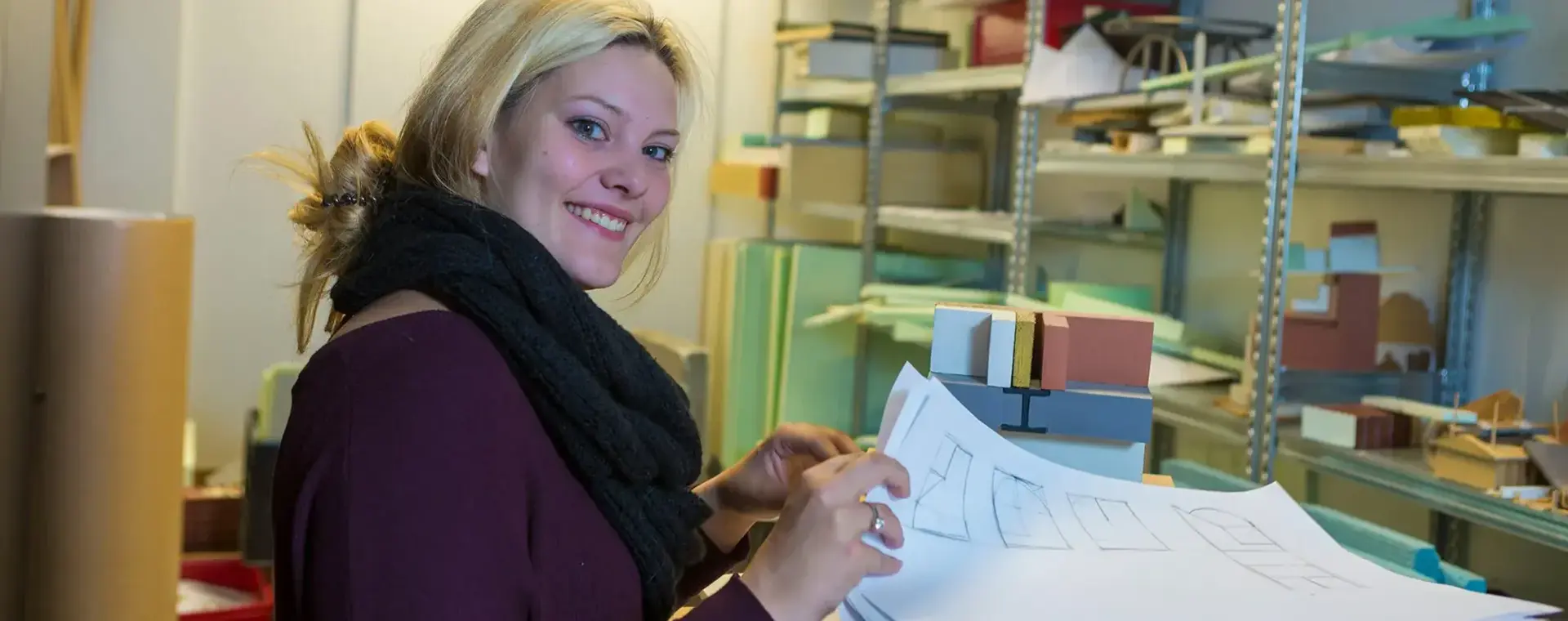 Student bouwkunde bekijkt bouwtekeningen.
